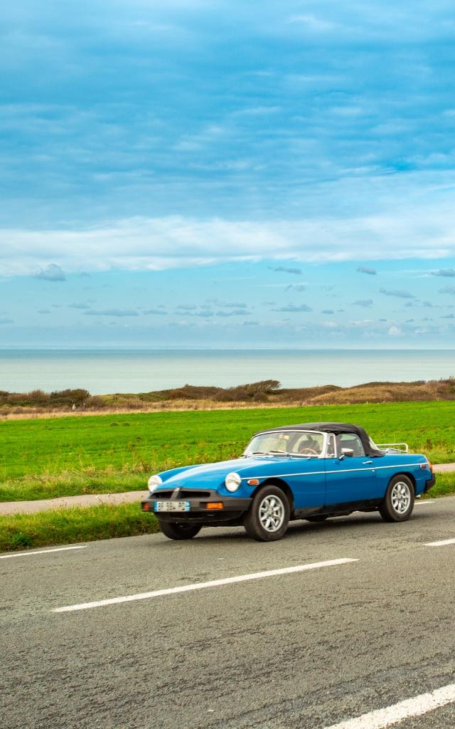 Oldtimer fährt auf einer leeren Straßen an den Deux Caps in Nordfrankreich. Copyright: CRTC Hauts-de-France - Benoît Bremer